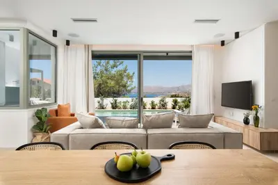 a living room with a couch and a table at Lux sea view villa by Chania LIving Stories in Chania Town
