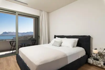 a bedroom with a bed with a view of the ocean at Lux sea view villa by Chania LIving Stories in Chania Town