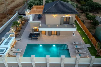 an aerial view of a house with a swimming pool at Villa Persephone in Tavronitis