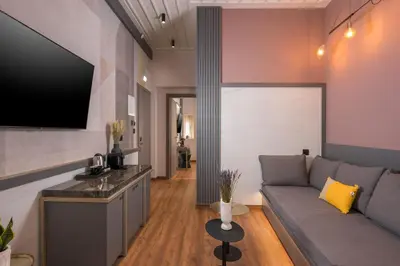 a living room with a couch and a flat screen tv at Veneri Boutique Suites in Chania Town