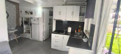 a kitchen with white cabinets and a sink and a stove at γαληνη in Vamos