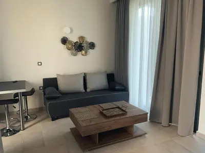 a living room with a couch and a table at King Crimson Luxury Apartments in Marathokefála
