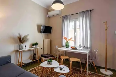 a living room with a couch and a table at EMMANUEL’S COZY HOUSE in Chania Town
