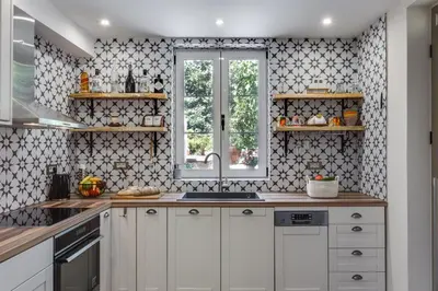 a kitchen with white cabinets and a window at Villa 4 DESTINA in Élos