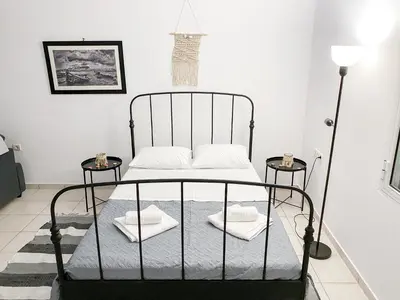 a black bed with towels on it in a room at Kampos View - Quiet House at the end of the Road, private pool in Kámbos