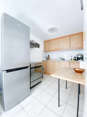 a kitchen with a white refrigerator and a table at Kampos View - Quiet House at the end of the Road, private pool in Kámbos