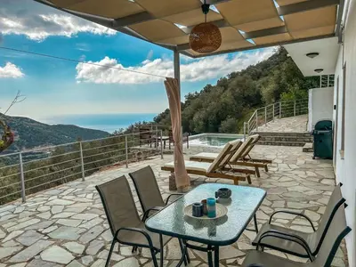 a table and chairs on a patio with a view at Kampos View - Quiet House at the end of the Road, private pool in Kámbos