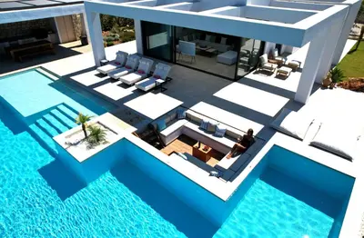 an aerial view of a house with a swimming pool at Chic Dream Villa in Agios Onoufrios