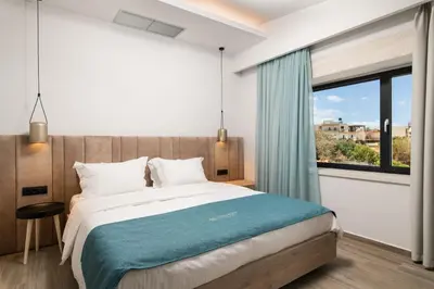 a bedroom with a large bed and a window at Chic Dream Villa in Agios Onoufrios