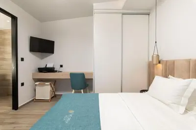 a hotel room with a bed and a desk at Chic Dream Villa in Agios Onoufrios