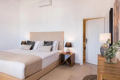a bedroom with a bed and a table with a lamp at Villa Thetis Sfakia in Sfakiá
