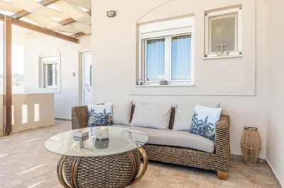 a living room with a couch and a table at kissamos seaside bliss in Kissamos