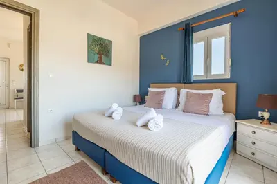 a bedroom with a large bed with towels on it at kissamos seaside bliss in Kissamos