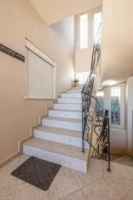 a set of stairs in a house with a wrought iron railing at kissamos seaside bliss in Kissamos