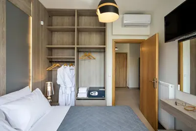 a bedroom with a bed and a closet at Elia Residences in Chania Town