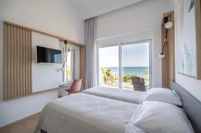 a bedroom with a bed and a view of the ocean at Isalos Seafront Villa I Sea fragrance in Chania Town