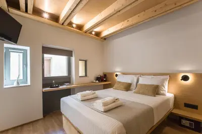 a bedroom with a large bed with two pillows on it at Thallos The Boutique in Chania Town