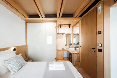 a small bedroom with a bed and a bathroom at Thallos The Boutique in Chania Town
