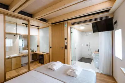 a bedroom with a bed and a bathroom with a shower at Thallos The Boutique in Chania Town