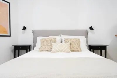a bedroom with a white bed with pillows on it at Marilias Luxury Studio Apartment in Kissamos
