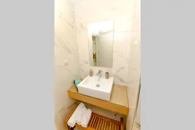 a bathroom with a sink and a mirror at Mare Monte Luxury Apartment in Kissamos