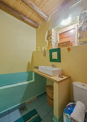a bathroom with a sink and a toilet at Hani Kastania - Chania retreat for families and groups for holidays and workshops in Sémbronas