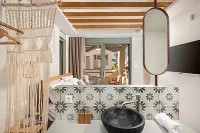a living room with a black bowl on a table at Villas Plumeria in Palaiochóra