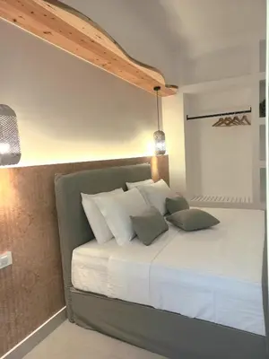 a bedroom with a large bed with white pillows at Sfakia Seaside luxury Suites in Khóra Sfakíon