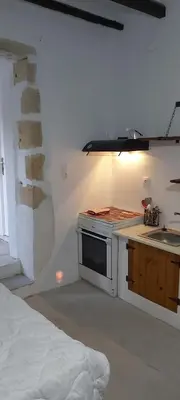 a white kitchen with a stove and a sink at Vryses Crete-Village Vibes in Vryses