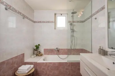 a bathroom with a tub and a shower and a sink at Ethyr City Living in Chania Town
