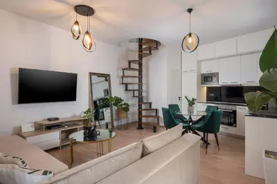 a living room with a couch and a table with chairs at Ethyr City Living in Chania Town