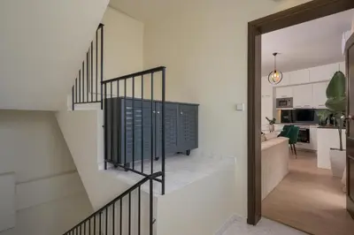 a staircase leading to a living room and a kitchen at Ethyr City Living in Chania Town