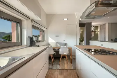 a kitchen with white cabinets and a counter with a window at Villa Enny, 3 BD with Private Heated Pool in Ayiá