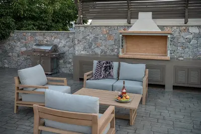 a patio with two chairs and a table and a grill at Villa Enny, 3 BD with Private Heated Pool in Ayiá