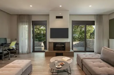 a living room with a couch and a fireplace at Villa Enny, 3 BD with Private Heated Pool in Ayiá
