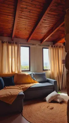 a living room with a couch and two windows at Villa Anthemida Chania in Ayiá