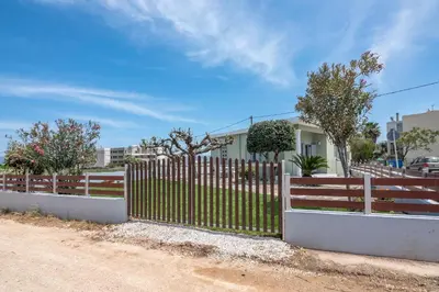 a wooden fence in front of a house at Lahardi - Seaside House in Kissamos