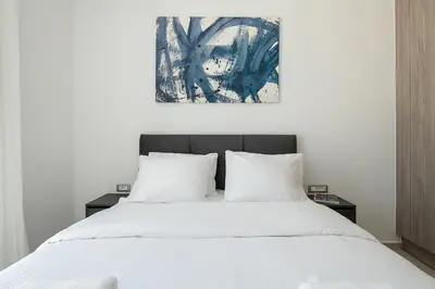 a bedroom with a white bed with two night stands at Kappa Residence in Chania Town