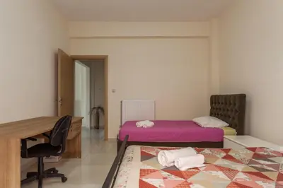 a room with two beds and a desk and a table at ΠΑΡΑΘΑΛΑΣΣΙΟ in Ayiá