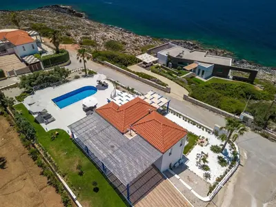 an aerial view of a house with a swimming pool at Villa Hemera ocean view private heated pool in Chorafakia