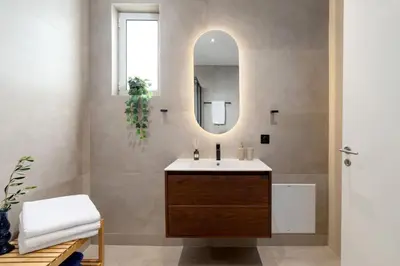 a bathroom with a sink and a mirror at Villa Hemera ocean view private heated pool in Chorafakia