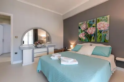 a bedroom with a blue bed and a mirror at Chania dream apartment in Chania Town
