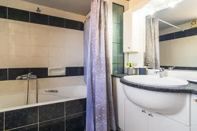a bathroom with a sink and a bath tub and a tubermott at Anastasia Home in Palaiochóra