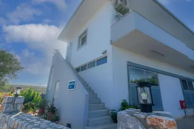a white house with a staircase in front of it at Anastasia Home in Palaiochóra