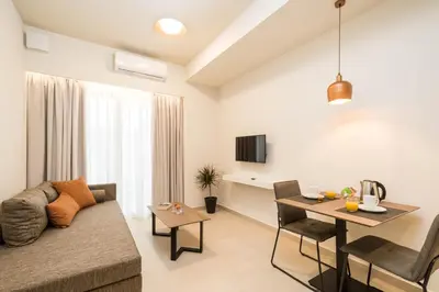 a living room with a couch and a table at ANTEL Suites & Apartments in Chania Town