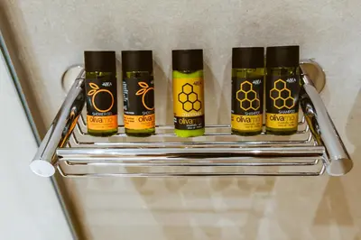 four bottles of honey on a rack in a refrigerator at ANTEL Suites & Apartments in Chania Town