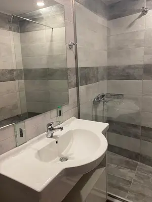 a bathroom with a white sink and a shower at Casa Argo in Chania Town
