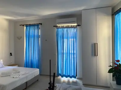 a bedroom with blue drapes and a bed at Casa Argo in Chania Town