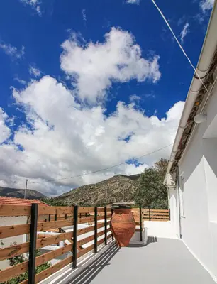 a balcony with a vase on the side of a building at Casa Elafonisi N2-10min from the beach in Plokamianá