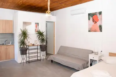a living room with a couch and a kitchen at Casa Elafonisi N2-10min from the beach in Plokamianá